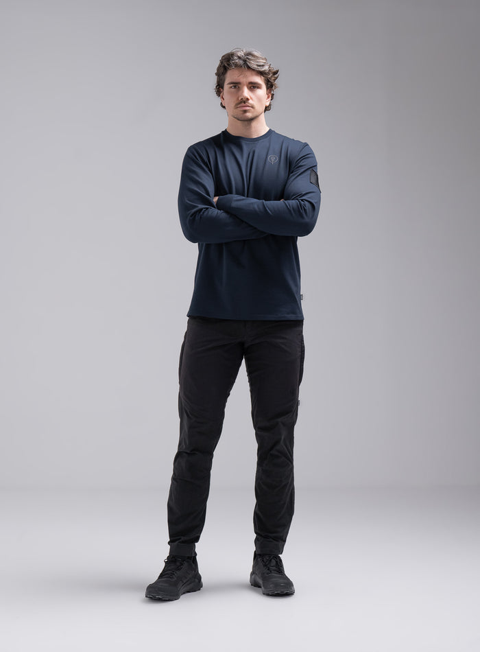 Jack Is 6ft 3" And Wears Size: L | Hem Studio Image Of Model Wearing Insignia Long Sleeve T-Shirt In Dark Sapphire (SS Model)