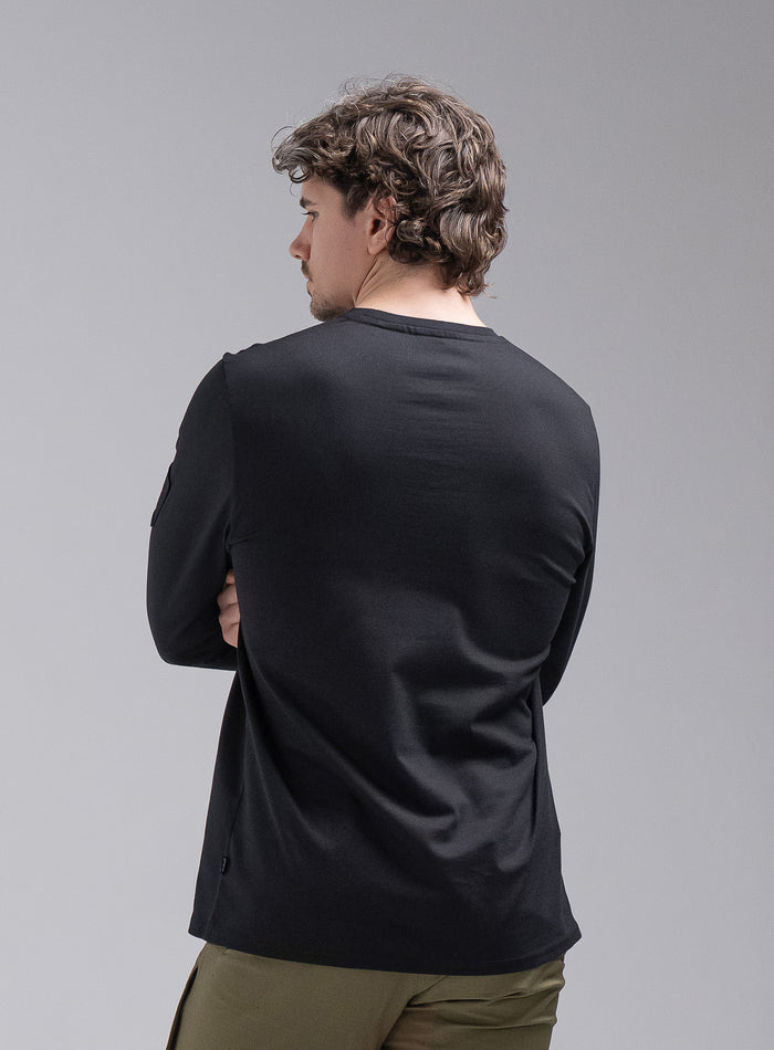 Jack Is 6ft 3" And Wears Size: L | Hem Studio Image Of Model Wearing Insignia Long Sleeve T-Shirt In Obsidian Black (SS Model)