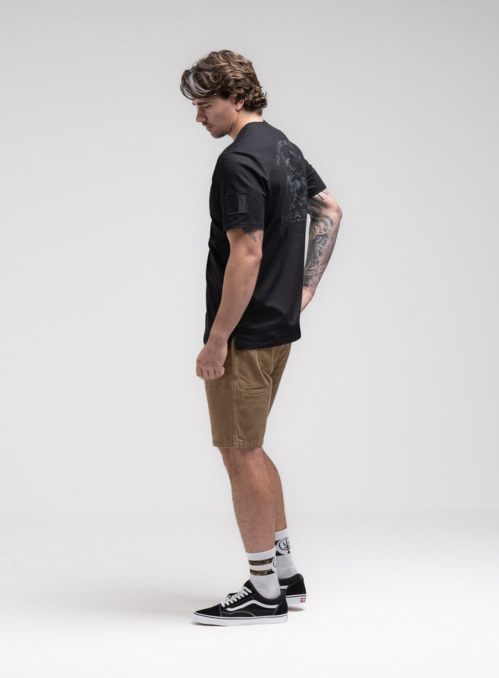 Jack Is 6ft 3" And Wears Size: L | Hem Studio Image Of Model Wearing Insignia T-Shirt - Dark Brigade In Obsidian Black (SS Model)