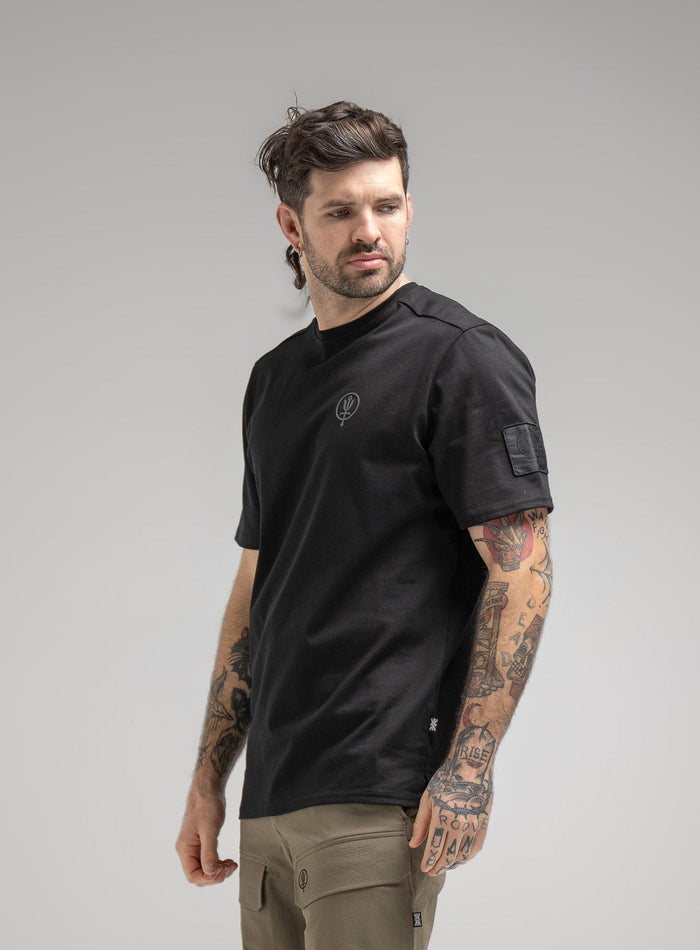 Bernie Is 6ft And Wears Size: M | Hem Studio Image Of Model Wearing Insignia T-Shirt - Good Breach In Obsidian Black (SS Model)