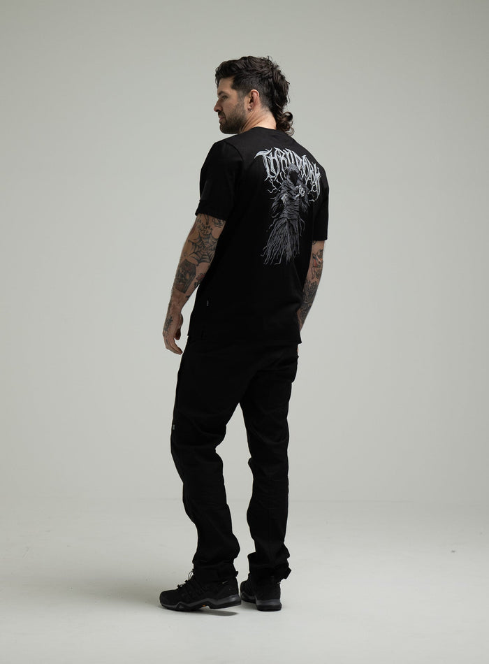 Bernie Is 6ft And Wears Size: M | Hem Studio Image Of Model Wearing Insignia T-Shirt - Wraith In Obsidian Black (SS Model)