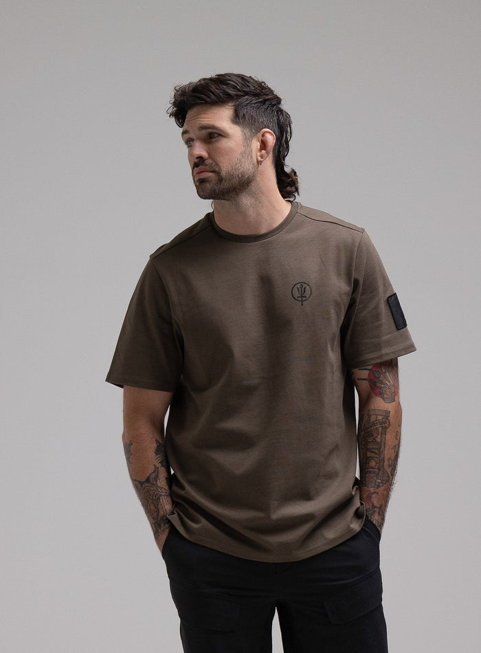 George Is 5ft 11" And Wears Size: S | Hem Studio Image Of Model Wearing Insignia T-Shirt G1 In Khaki (SS Model)