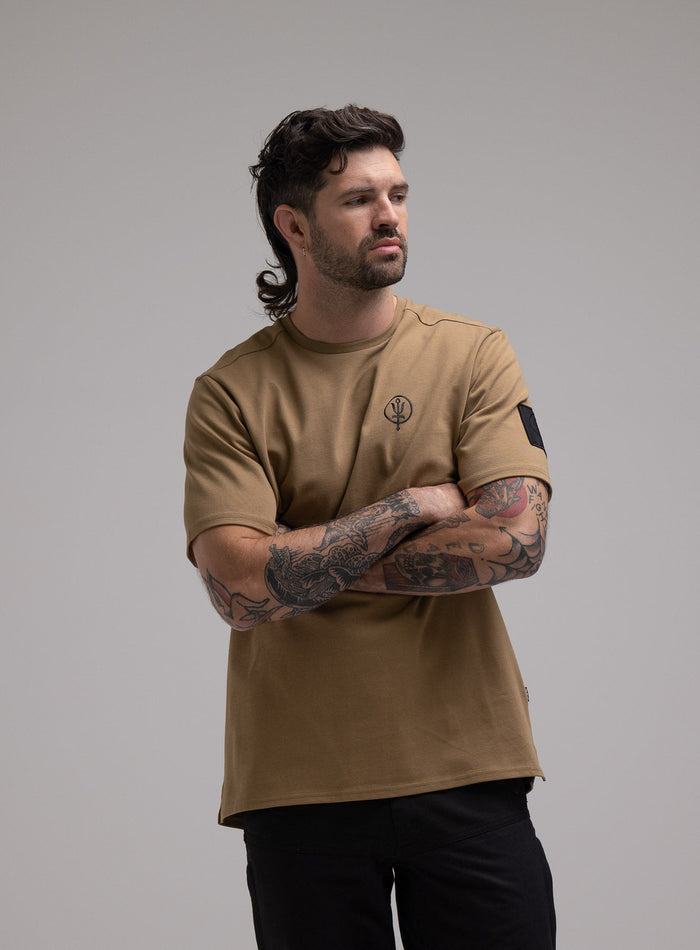 George Is 5ft 11" And Wears Size: S | Hem Studio Image Of Model Wearing Insignia T-Shirt G1 In Sand (SS Model)