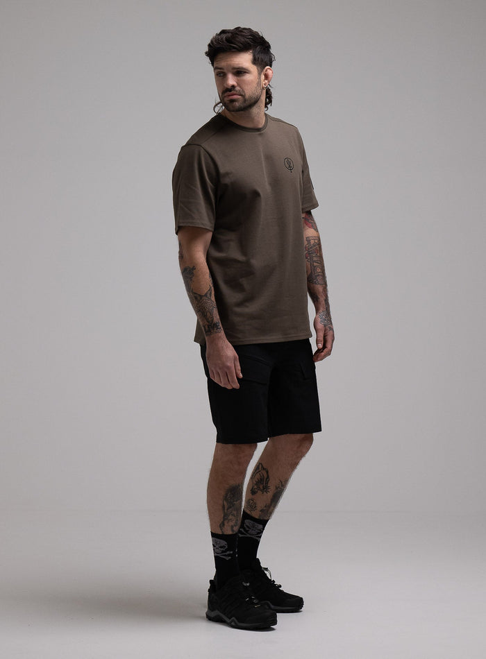 George Is 5ft 11" And Wears Size: S | Hem Studio Image Of Model Wearing Insignia T-Shirt G1 In Khaki (SS Model)