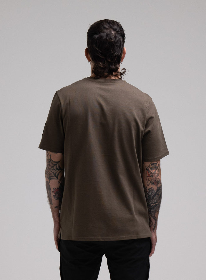 George Is 5ft 11" And Wears Size: S | Hem Studio Image Of Model Wearing Insignia T-Shirt G1 In Khaki (SS Model)