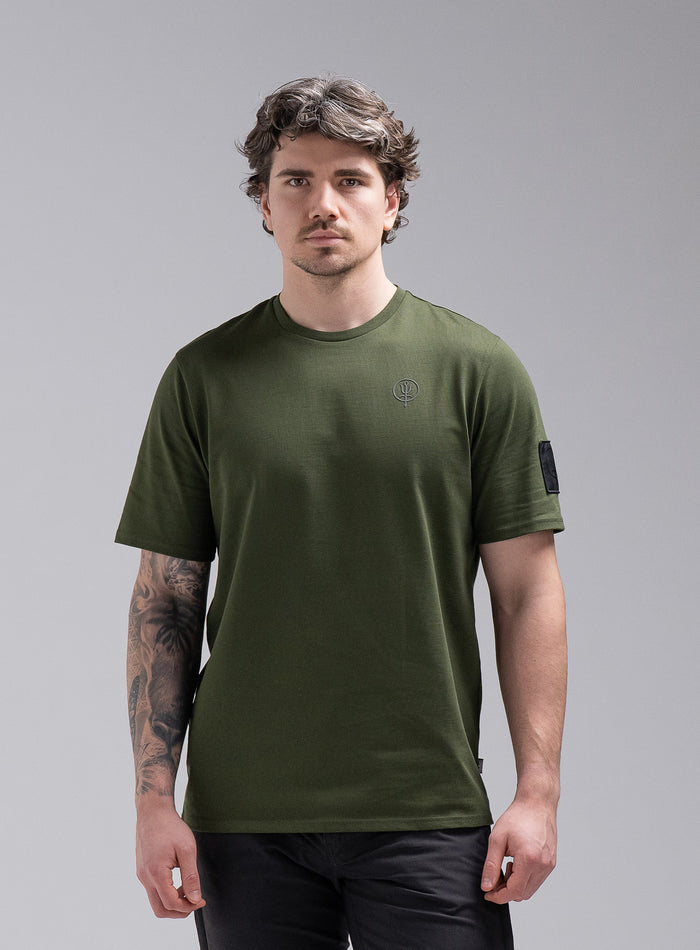 Jack Is 6ft 3" And Wears Size: L | Hem Studio Image Of Model Wearing Insignia Short Sleeve T-Shirt In Forest Green (SS Model)