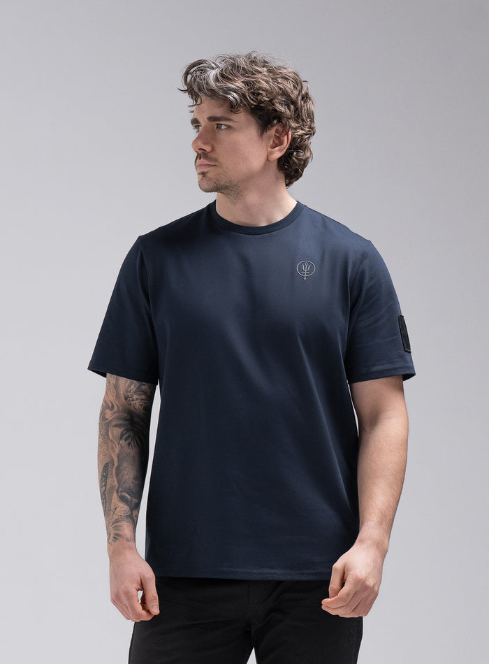 Jack Is 6ft 3" And Wears Size: L | Hem Studio Image Of Model Wearing Insignia Short Sleeve T-Shirt In Dark Sapphire (SS Model)