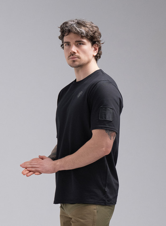Jack Is 6ft 3" And Wears Size: L | Hem Studio Image Of Model Wearing Insignia Short Sleeve T-Shirt In Obsidian Black (SS Model)