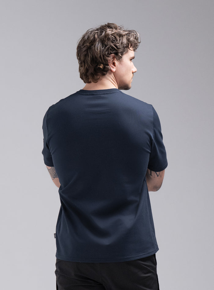 Jack Is 6ft 3" And Wears Size: L | Hem Studio Image Of Model Wearing Insignia Short Sleeve T-Shirt In Dark Sapphire (SS Model)