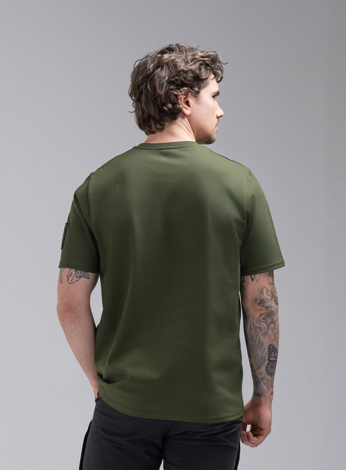 Jack Is 6ft 3" And Wears Size: L | Hem Studio Image Of Model Wearing Insignia Short Sleeve T-Shirt In Forest Green (SS Model)