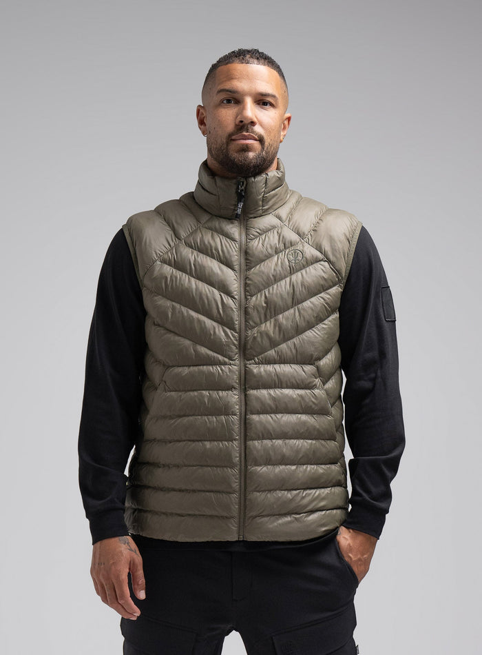 Dj Is 6ft 4" And Wears Size: Xl | Hem Studio Image Of Model Wearing Ithax Gilet In Olive Green (SS Model)
