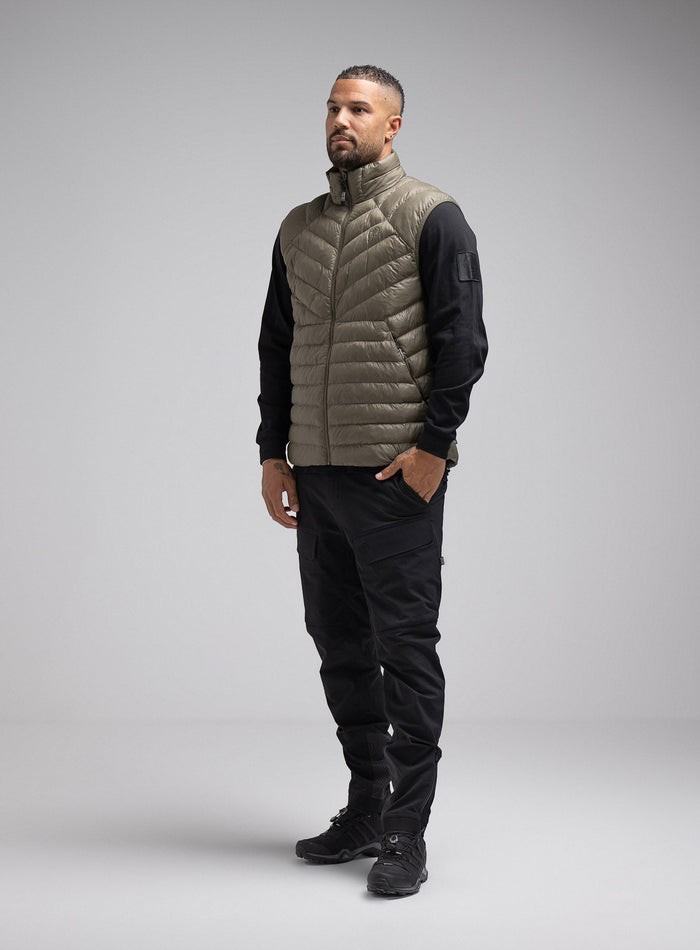 Dj Is 6ft 4" And Wears Size: Xl | Hem Studio Image Of Model Wearing Ithax Gilet In Olive Green (SS Model)