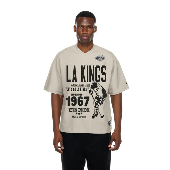 The Male model is wearing LA Kings NHL Throwback Prep Light Beige T-Shirt 1
