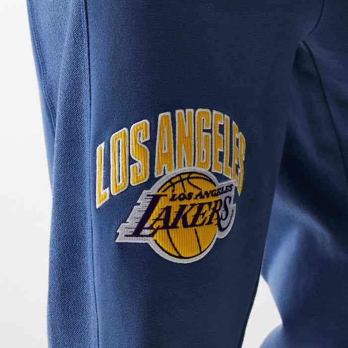 The Male model is wearing LA Lakers NBA Arch Graphic Dark Blue Joggers 6