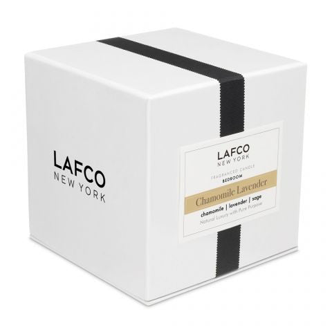 The LAFCO - BEDROOM CHAMOMILE LAVENDER 6.5OZ candle features a soothing blend of lavender and chamomile in a cream-colored wax, set in a simple clear glass container, perfect for relaxing bedroom ambiance.