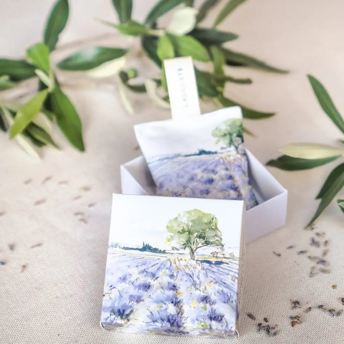 L'AUGUSTE PROVENCE - FRENCH LAVENDER SACHET AND GIFT BOX: includes two organic sachets with watercolor lavender field designs, "L'AUGUSTE" fabric tags, all elegantly presented in a box labeled “Fabriqué en Provence, FRANCE.”.
