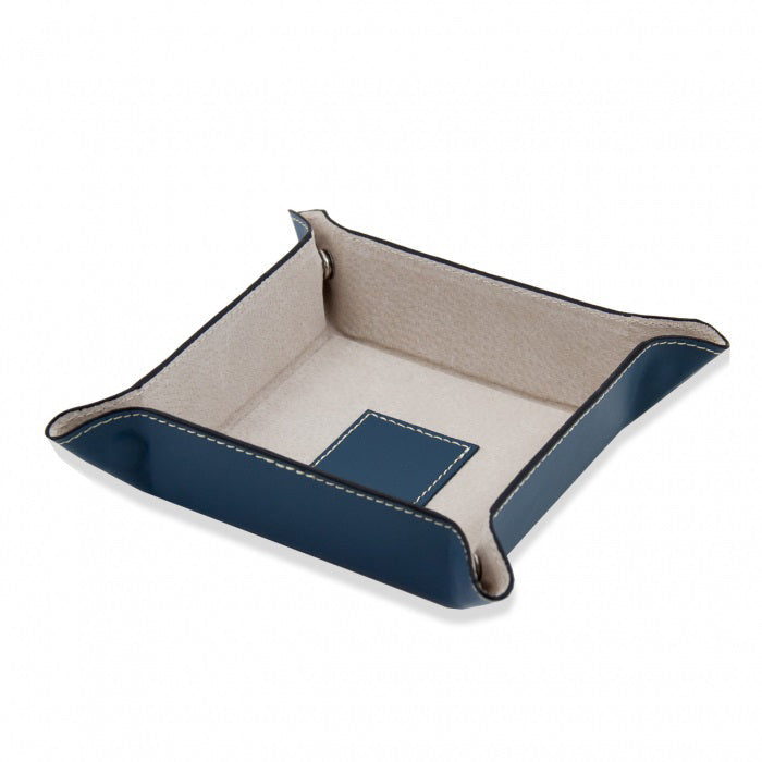 The LEATHER VALET IN BLUE by BEYBERK INTERNATIONAL features blue leather, a beige pigskin leather lining, stitched edges, raised sides, and secure corner snaps. Shown empty for display.