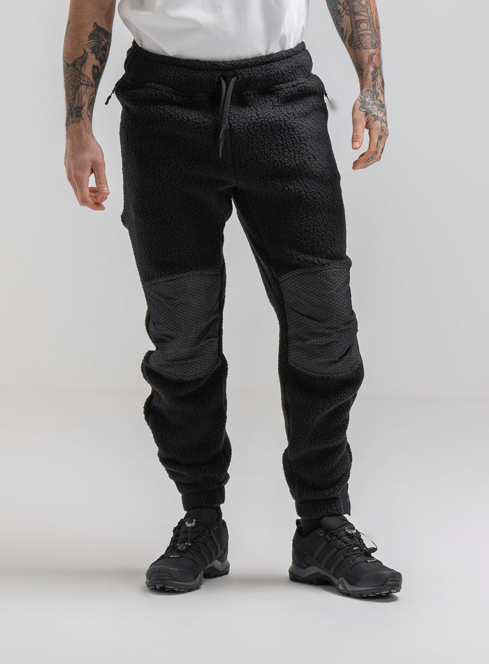Bernie Is 6ft And Wears Size: M | Hem Studio Image Of Model Wearing Mantra Black Ops Pants In Obsidian Black (SS Model)