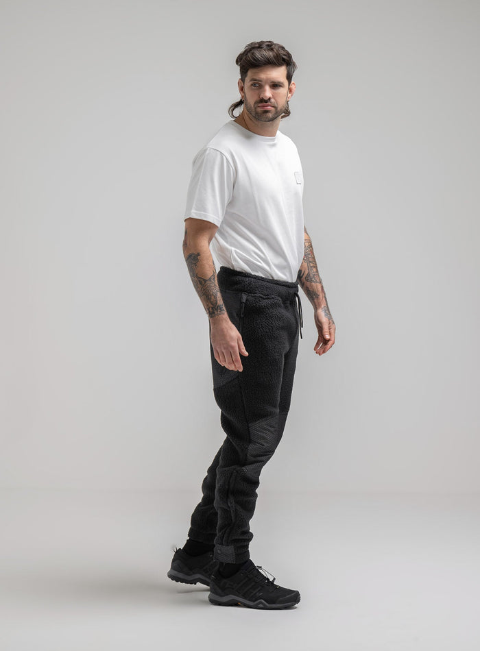 Bernie Is 6ft And Wears Size: M | Hem Studio Image Of Model Wearing Mantra Black Ops Pants In Obsidian Black (SS Model)