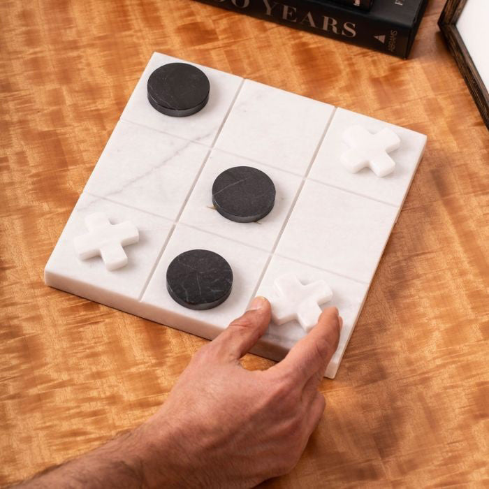 The BEYBERK INTERNATIONAL MARBLE TIC TAC TOE SET features white Xs and black circles on a white grid, with a winning row of Xs displayed at the bottom.