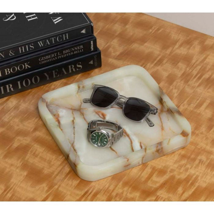 The MARBLE TRAY AND CATCH ALL by BEYBERK INTERNATIONAL is a small, square marble tray with rounded edges, a white base, and natural brown/beige veining—ideal for luxury décor. Shown empty against a plain white background.