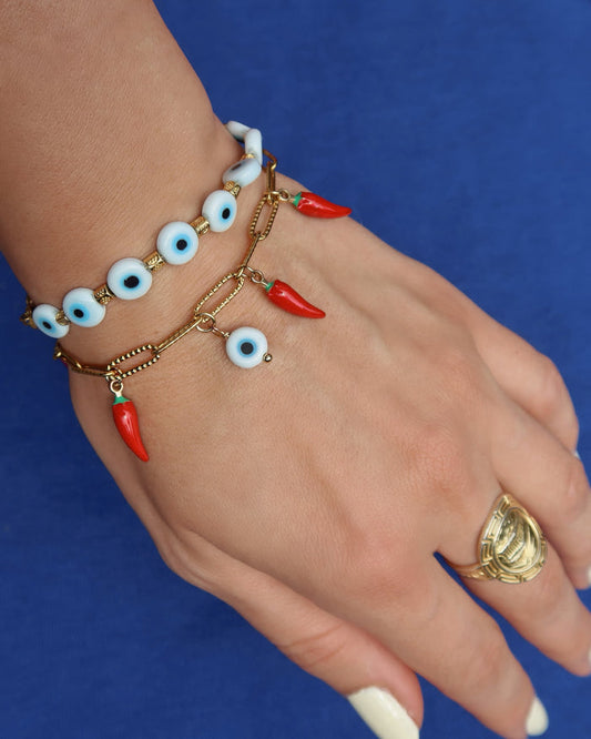 Gold paperclip chain bracelet with a white evil eye charm and red Italian cornicello charms for good luck, lucky charm bracelet made in Greece