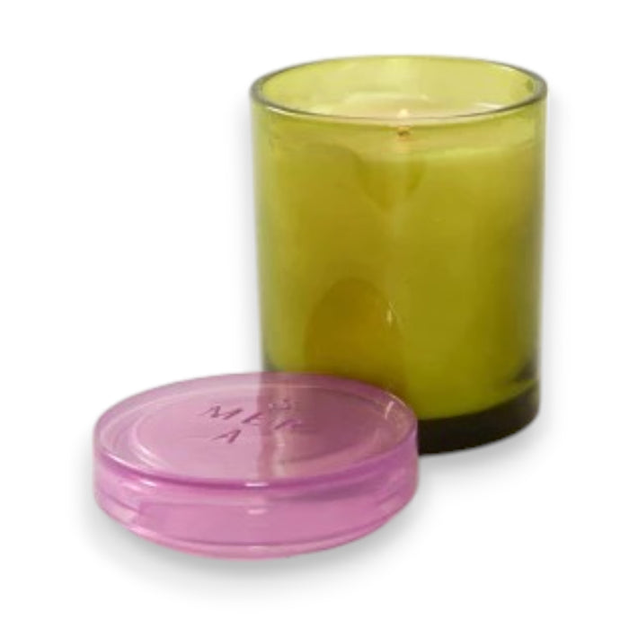 The MERSEA - SUMMER IN PROVENCE JOLIE JAR CANDLE by MERSEA features a green glass jar with a translucent pink lid, shown on a white background. Its smooth, cylindrical design makes it ideal for holding summer-inspired scents.