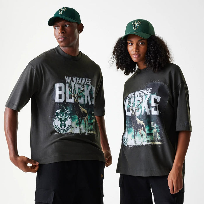 The Male model is wearing Milwaukee Bucks NBA Washed Graphic Grey T-Shirt 1