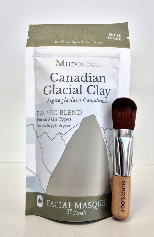 Mudology Canadian Glacial Clay facial masque package with a brush on a white background