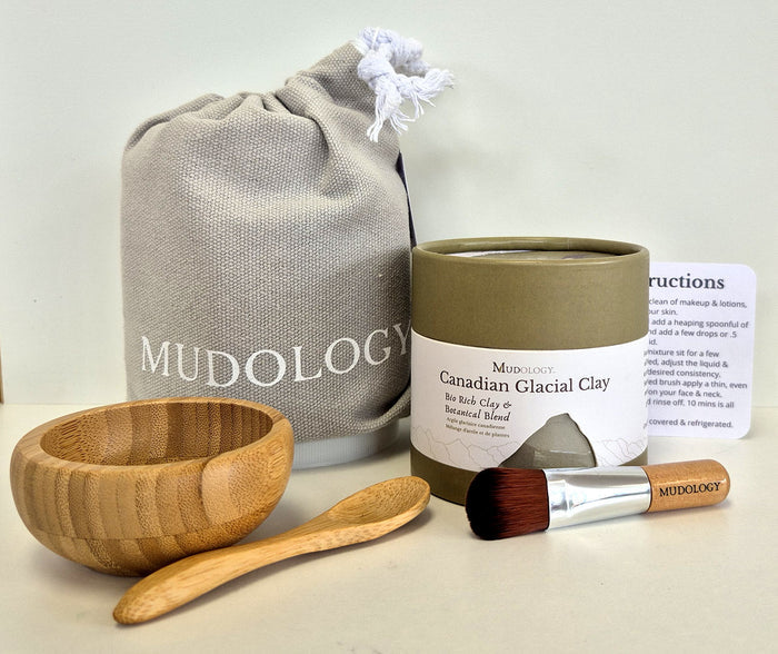 Mudology Canadian Glacial Clay facial masque spa kit with 100g tub of clay, wood bowl and spoon, applicator brush, cotton pouch and instructions