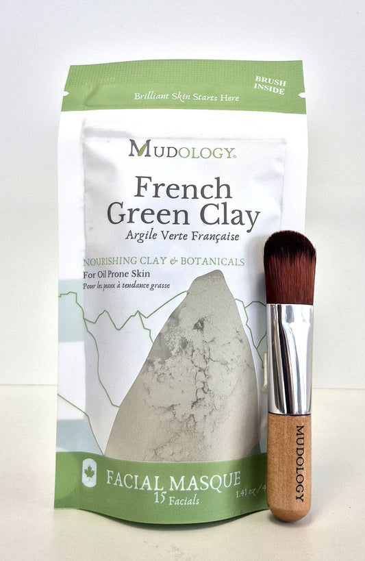 Mudology French Green Clay facial masque package with a brush on a white background
