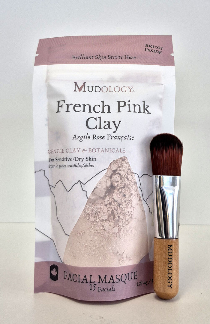 Mudology French Pink Clay facial masque package with a brush on a white background