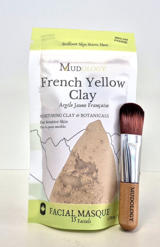 Mudology French Yellow Clay facial masque package with a brush on a white background