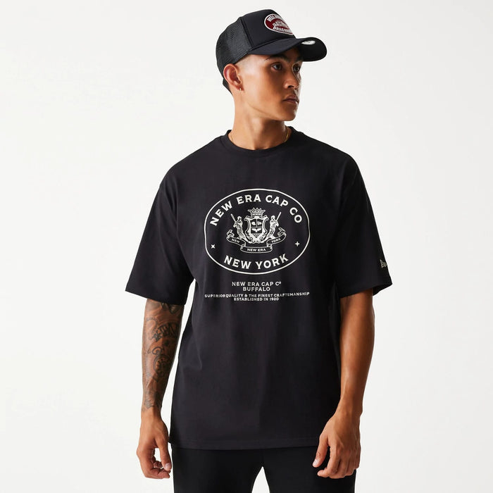 The Male model is wearing New Era Crest Black Oversized T-Shirt 1