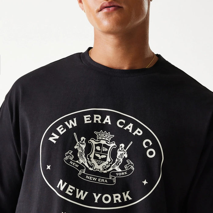 The Male model is wearing New Era Crest Black Oversized T-Shirt 6