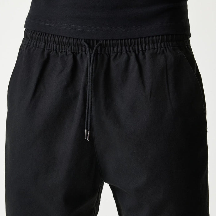 The Male model is wearing New Era Japan Woven Black Shorts 4