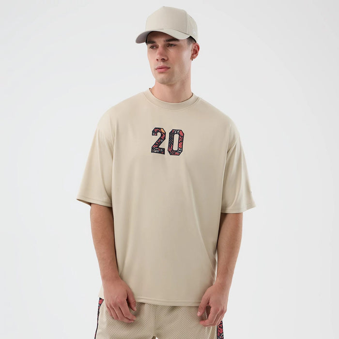The Male model is wearing New Era Mesh Infill Light Beige Oversized T-Shirt 1