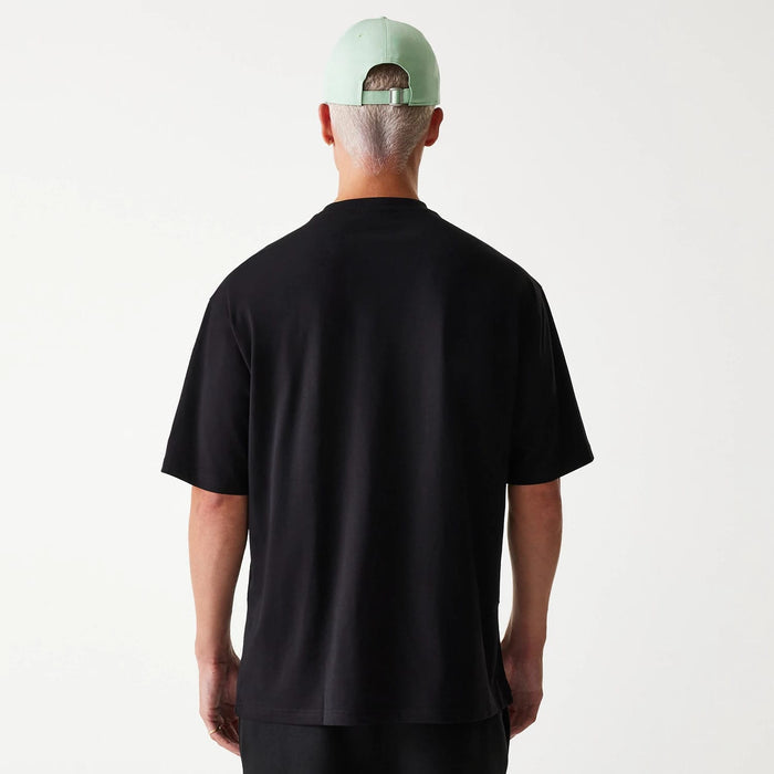 The Male model is wearing New Era Outdoor Graphic Black Oversized T-Shirt 2