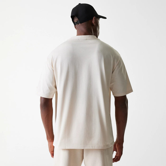 The Male model is wearing New Era Tech Light Beige Oversized T-Shirt 2
