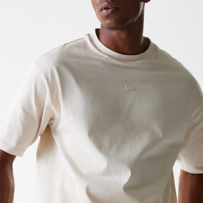 The Male model is wearing New Era Tech Light Beige Oversized T-Shirt 5