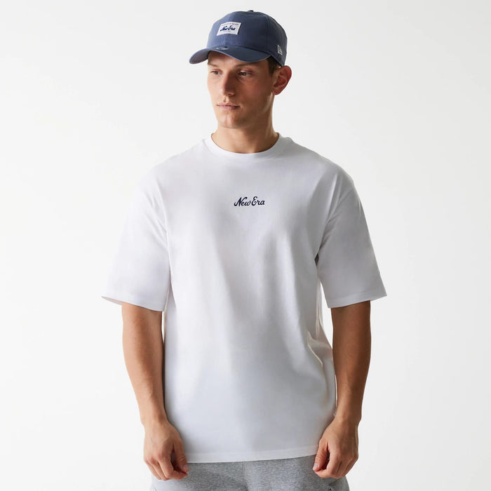 The Male model is wearing New Era Trucker Patch White Oversized T-Shirt 1
