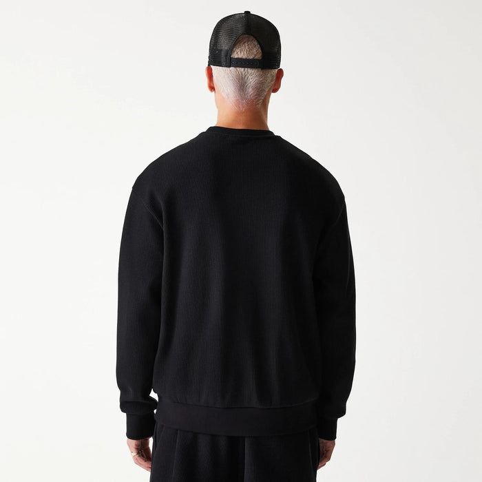 The Male model is wearing New Era Waffle Black Oversized Crew Neck Sweater 2