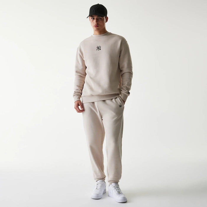 The Male model is wearing New York Yankees MLB League Essential Cream Joggers 8