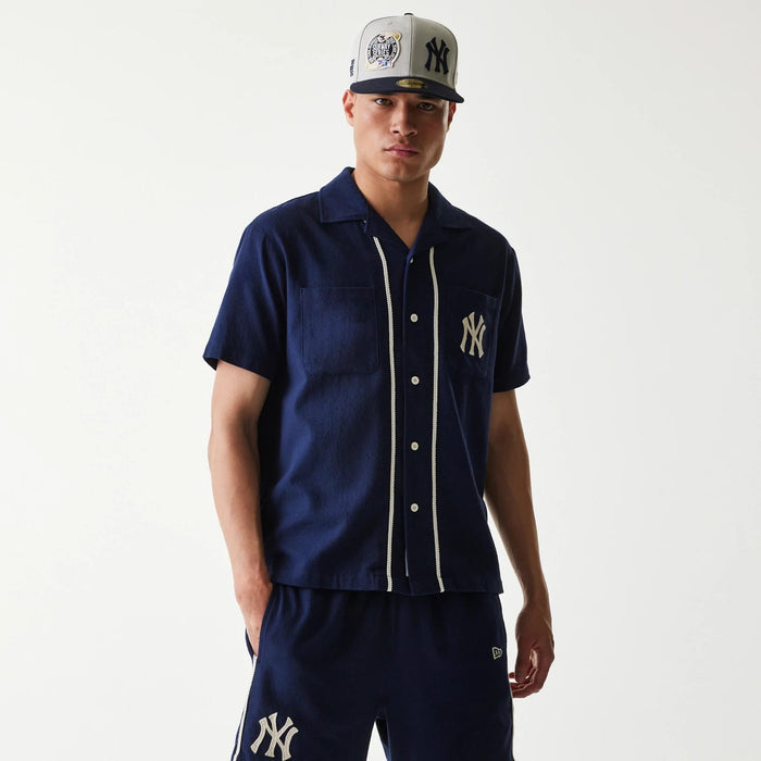The Male model is wearing New York Yankees MLB Piping Navy Short Sleeve Shirt 1
