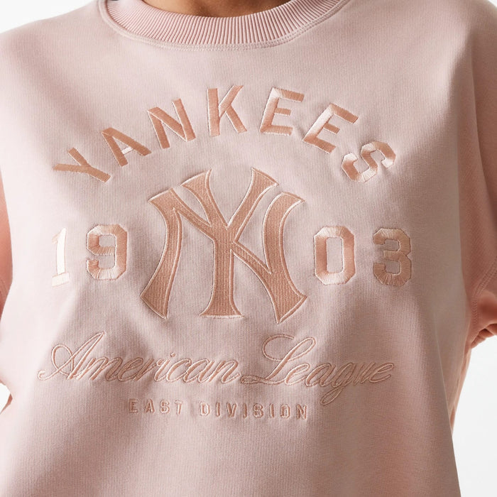 The Female model is wearing New York Yankees Womens MLB Tonal Graphic Pastel Pink Oversized Crew Neck Sweater 4