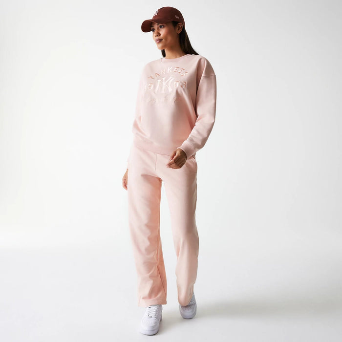 The Female model is wearing New York Yankees Womens MLB Tonal Graphic Pastel Pink Oversized Crew Neck Sweater 8