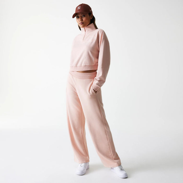 The Female model is wearing New York Yankees Womens MLB Tonal Pastel Pink Cropped 1/4 Zip Sweater 8