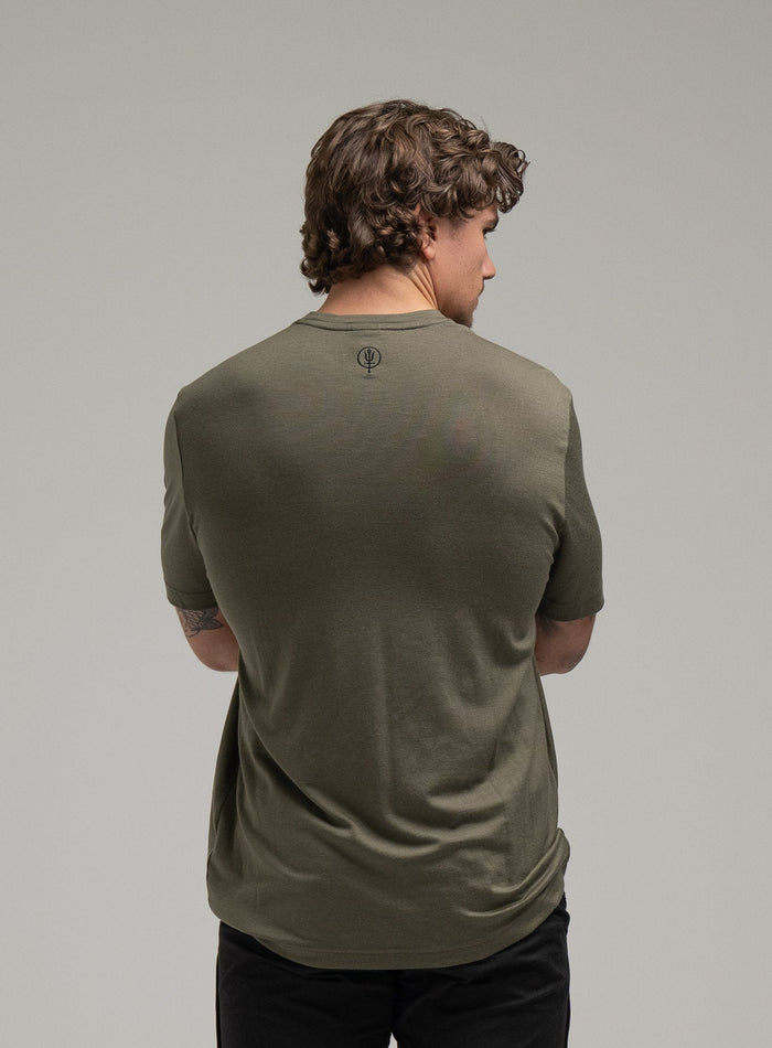 Jack Is 6ft 3" And Wears Size: L | Hem Studio Image Of Model Wearing Oryon 72Hr Merino T-Shirt In Green (SS Model)