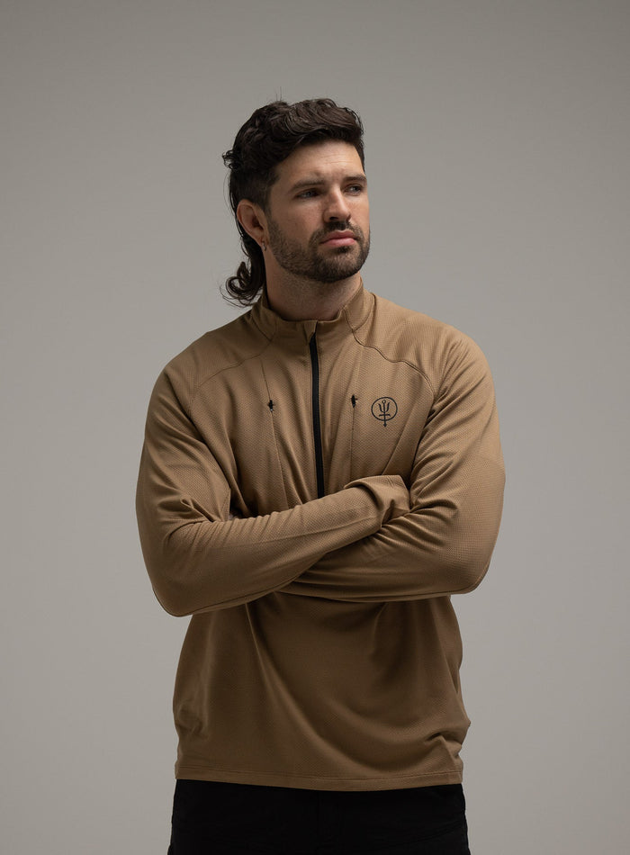 Bernie Is 6ft And Wears Size: M | Hem Studio Image Of Model Wearing Oryon Delta Long Sleeve T-Shirt In Sand (SS Model)