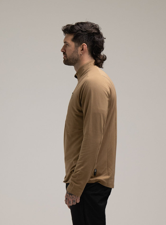 Bernie Is 6ft And Wears Size: M | Hem Studio Image Of Model Wearing Oryon Delta Long Sleeve T-Shirt In Sand (SS Model)